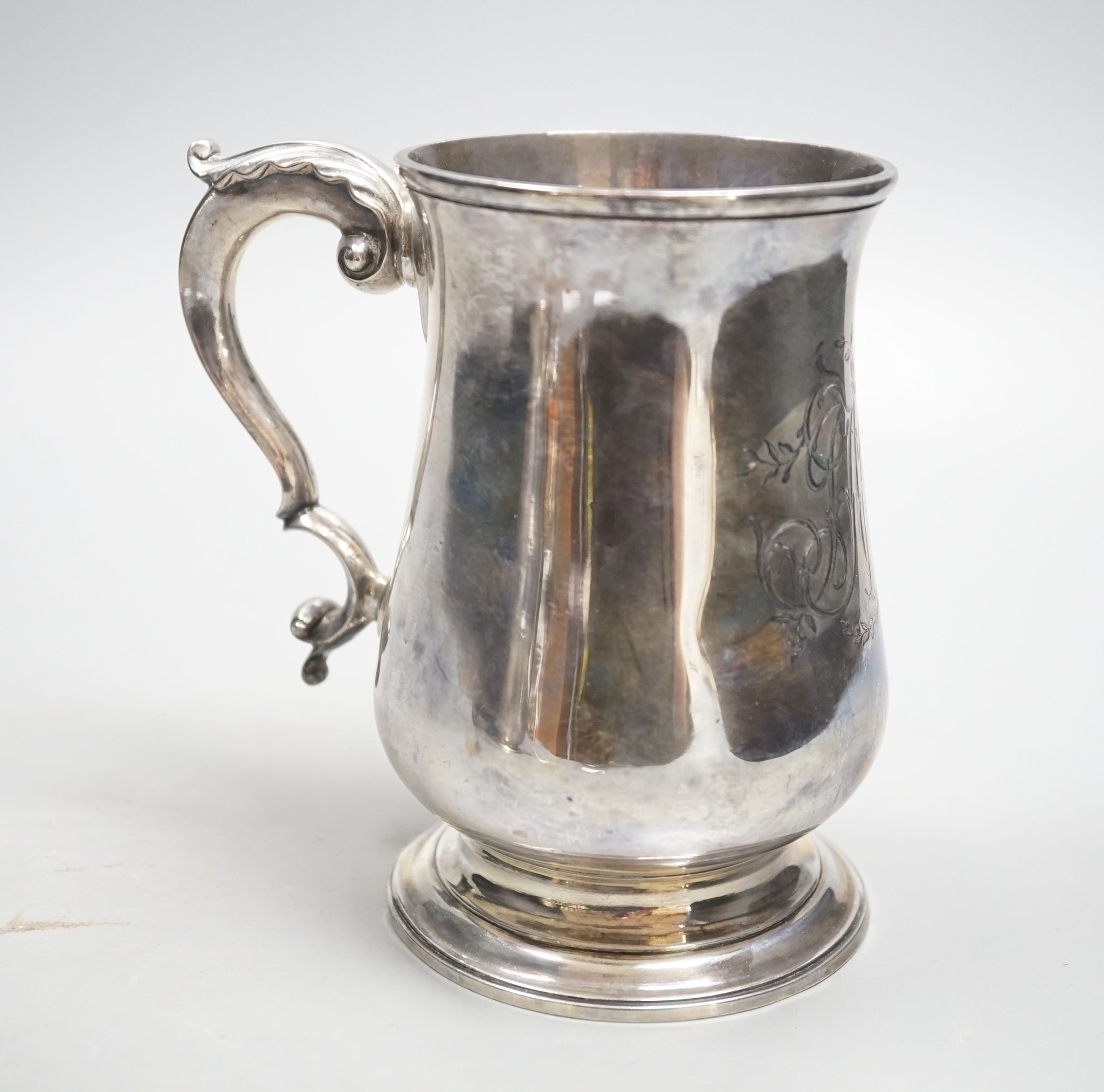 A George III silver baluster mug, with later engraved monogram, John Chapman II, London, 1773, 13.6cm, 14oz.